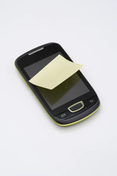 Post it on smartphone Royalty Free Stock Photos
