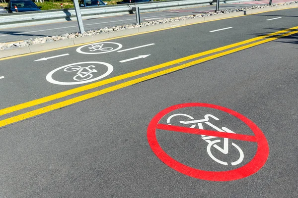 City street asphalt road with separated two way direction bicycle lane route sign mark and bike riding prohibited symbol. Modern eco urban commute transportation infastrucutre organization. — Φωτογραφία Αρχείου