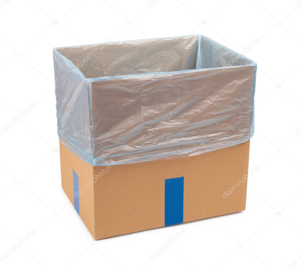 Opened cardboard box with a plastic bag inside. Isolated on white background.
