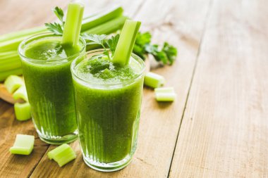 Green smoothie with celery and spinach in two glasses