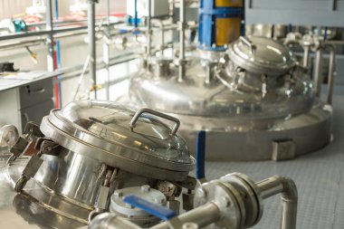 Tanks for chemical mixing on chemical plant. Concept: Manufacturing