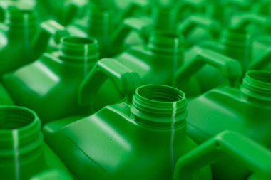 Empty plastic cans green color for liquids. Concept: Manufacturing