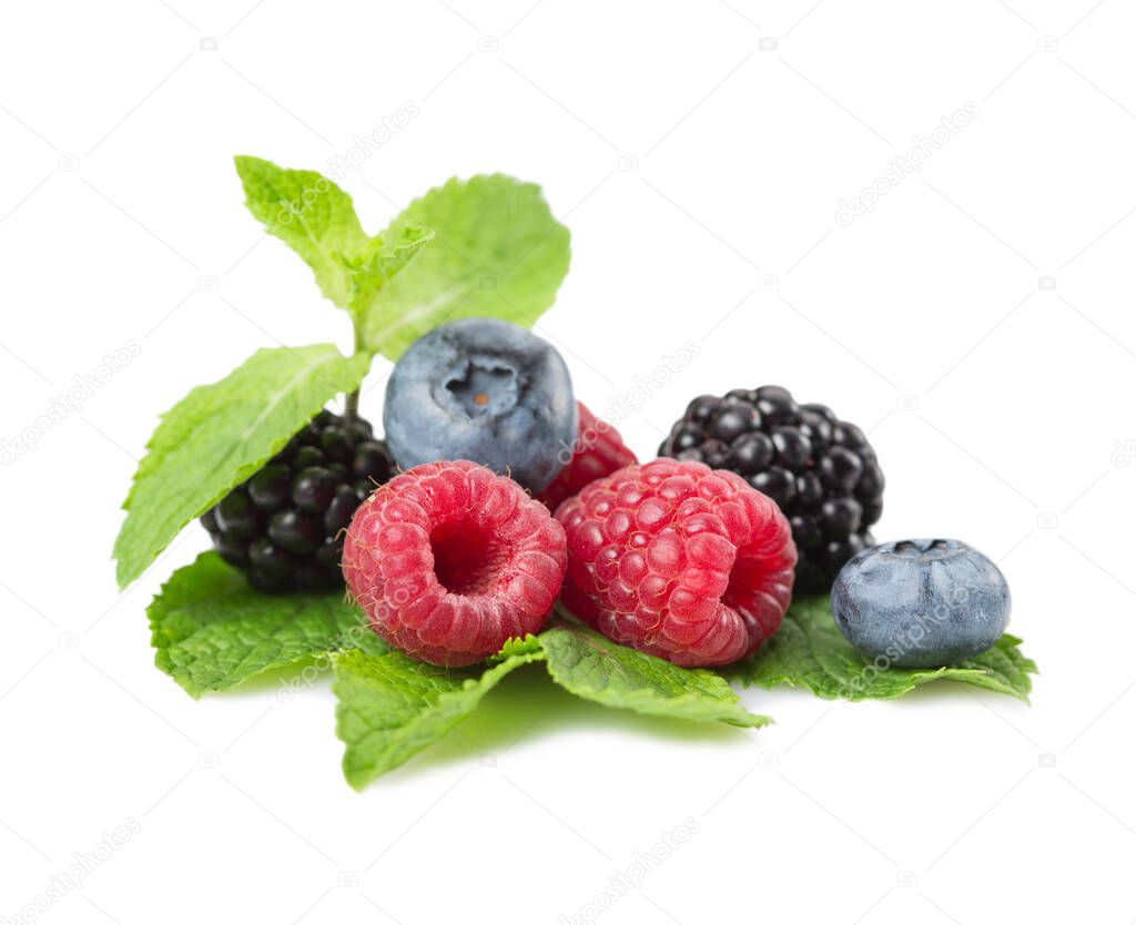 Mix of berries. Raspberries, blueberries and blackberries on a white background with leaves mint. Isolated.