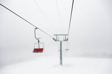 ski-lift in fog on a winter day
