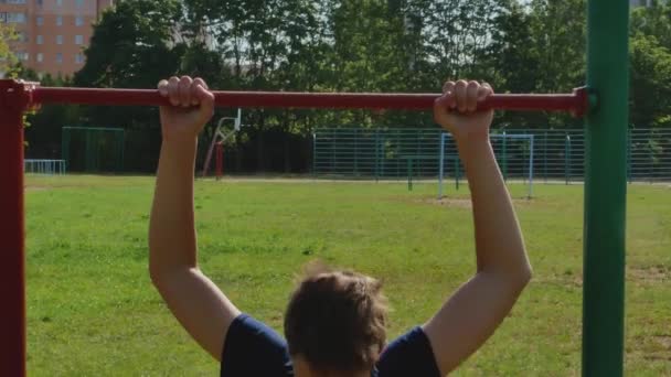 14 year old child is training to pull up on the horizontal bar. — Stock Footage 14 year old child is training to pull up on the horizontal bar. Video Clip