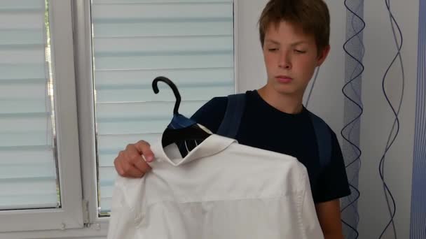 Το αγόρι πάει το πουκάμισό του στο σχολείο.. — Αρχείο Βίντεο