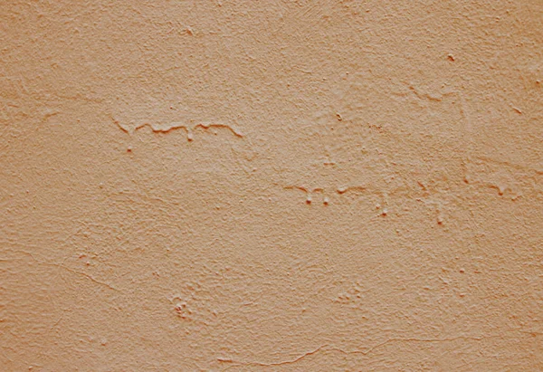 Texture of leaked brown paint on stucco.