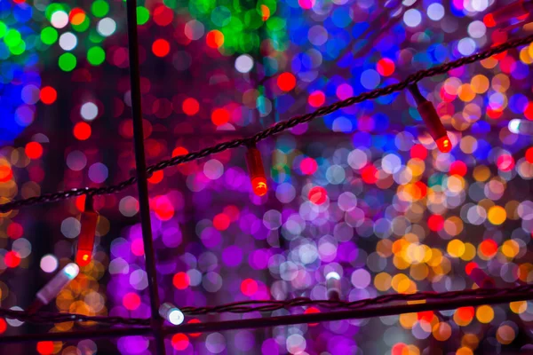 Background of beautiful colorful bokeh from electric garlands. — Stock Photo, Image
