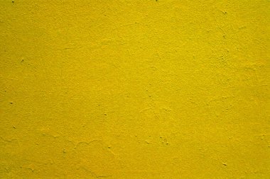 Duvarda eski parlak sarı boya dokusu.