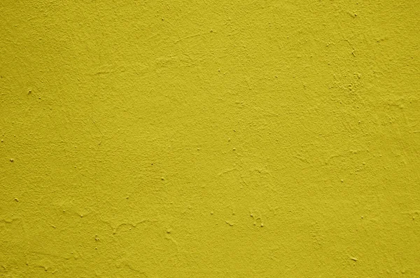 stock image Texture of old bright yellow stucco on the wall.