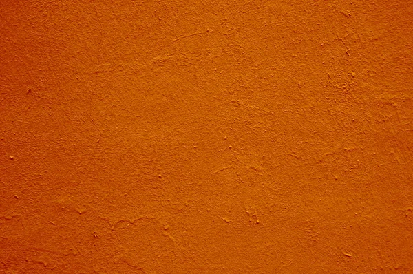 석고 위에 있는 오래 된 오렌지색 페인트의 노골적 인 질감. — 스톡 사진