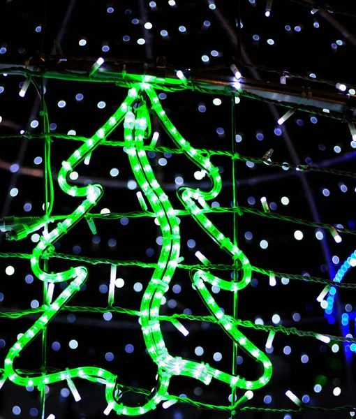 Glowing electric illumination of Christmas tree shaped lights. — Stock Photo, Image