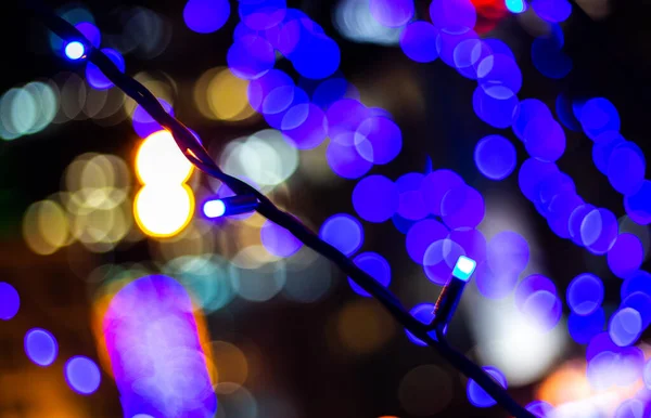 Enigmatic and romantic bokeh from blue glowing garlands. — Stock Photo, Image