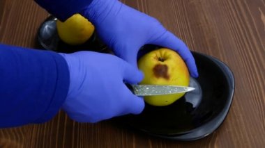 Removing the rot from the apple. 