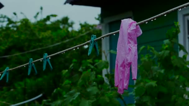 Rubber gloves on a clothespin rope blurred background. — Stock Video