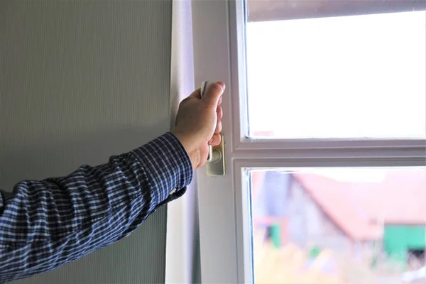 person opening a window