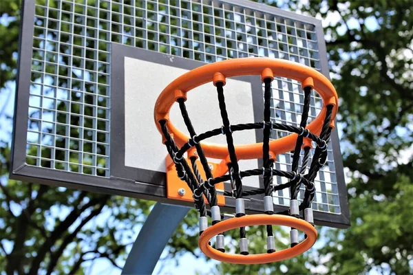 basketball hoop and net against blue sky