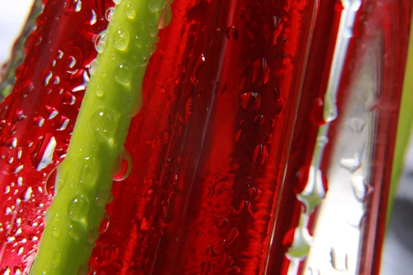 Shiny water drops sprayed on textured red surface. — Stock Photo, Image