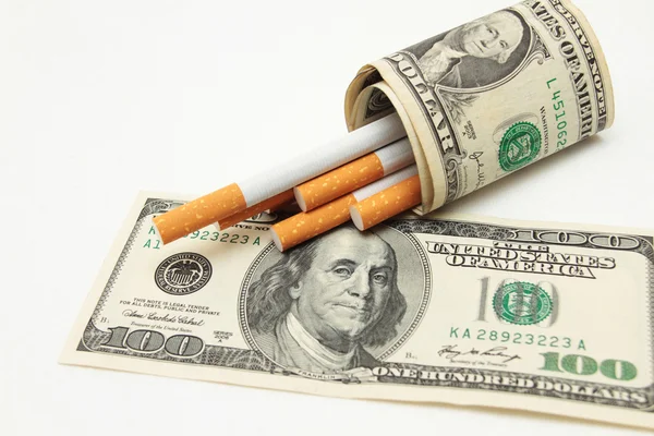 Cigarettes and money. expensive habit. white background - horizontal photo. — Stock Photo, Image
