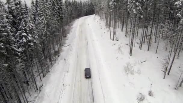 Aerial shot of snow-covered road in the countryside Carpathian Mountains — Stock Video