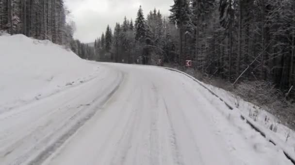 Aerial shot of snow-covered road in the countryside Carpathian Mountains — Stock Video