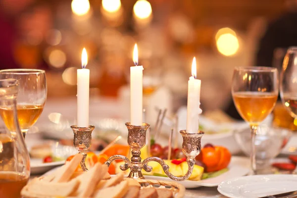 The burning candles in a candlestick on a festive table Stock Picture