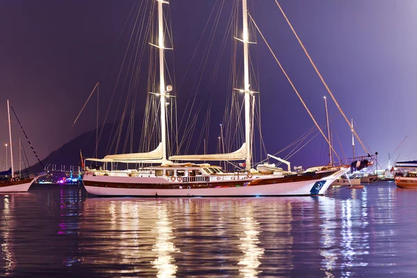 Beautiful two-masted yacht moored in the harbor in the evening — Stock Photo, Image