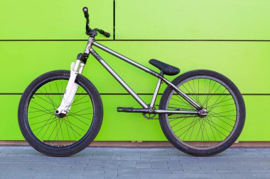 KYIV, UKRAINE - May 22, 2015: Stunt bike stands against green wall background.