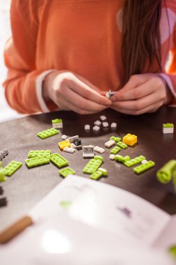 Girl building blocks of the toy clipart