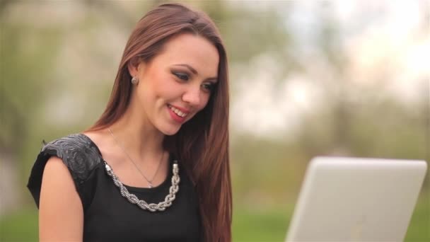 Девушка общается через Интернет с ноутбуком о природе — стоковое видео