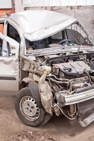 Crashed silver car with broken roof, front view — Stock Photo, Image