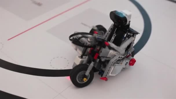 Black plastic mechanical robot on bike — Stock Video