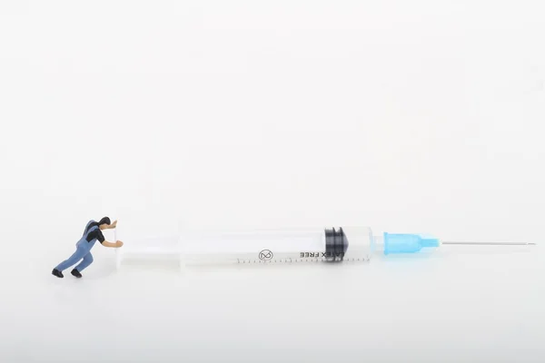 Miniature Man Pushing Big Syringe — 스톡 사진