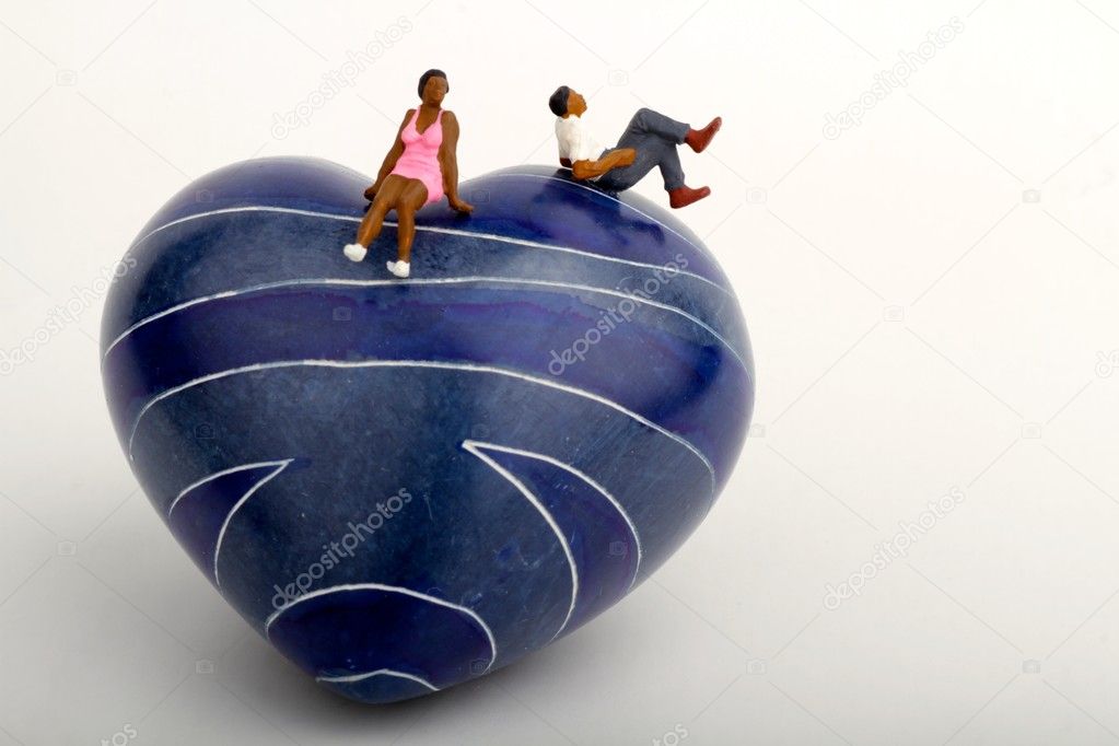 miniature of a black couple sitting on a blue stone heart