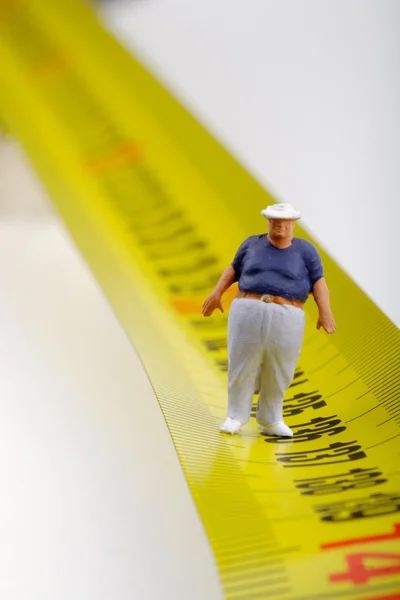 Fat man on a measurer - miniature — Stock Photo, Image