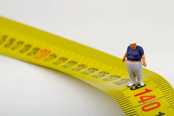 Fat man on a measurer - miniature — Stock Photo, Image