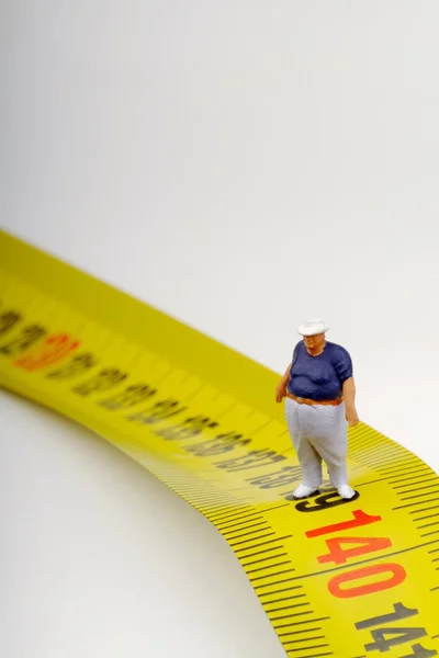 Fat man on a measurer - miniature — Stock Photo, Image