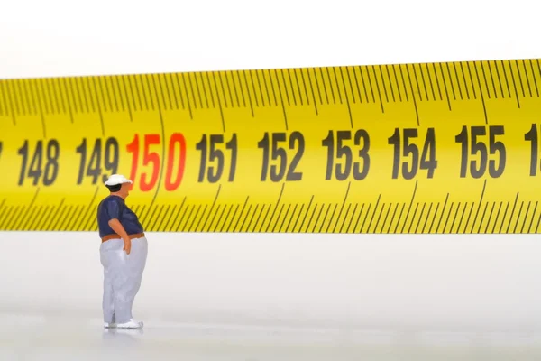 Fat man on a measurer - miniature — Stock Photo, Image