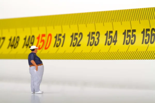 Fat man on a measurer - miniature — Stock Photo, Image