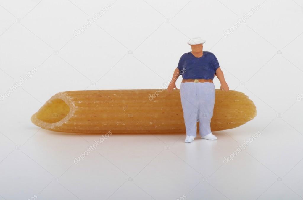 Fat man miniature and pasta - obesity and overweight concept