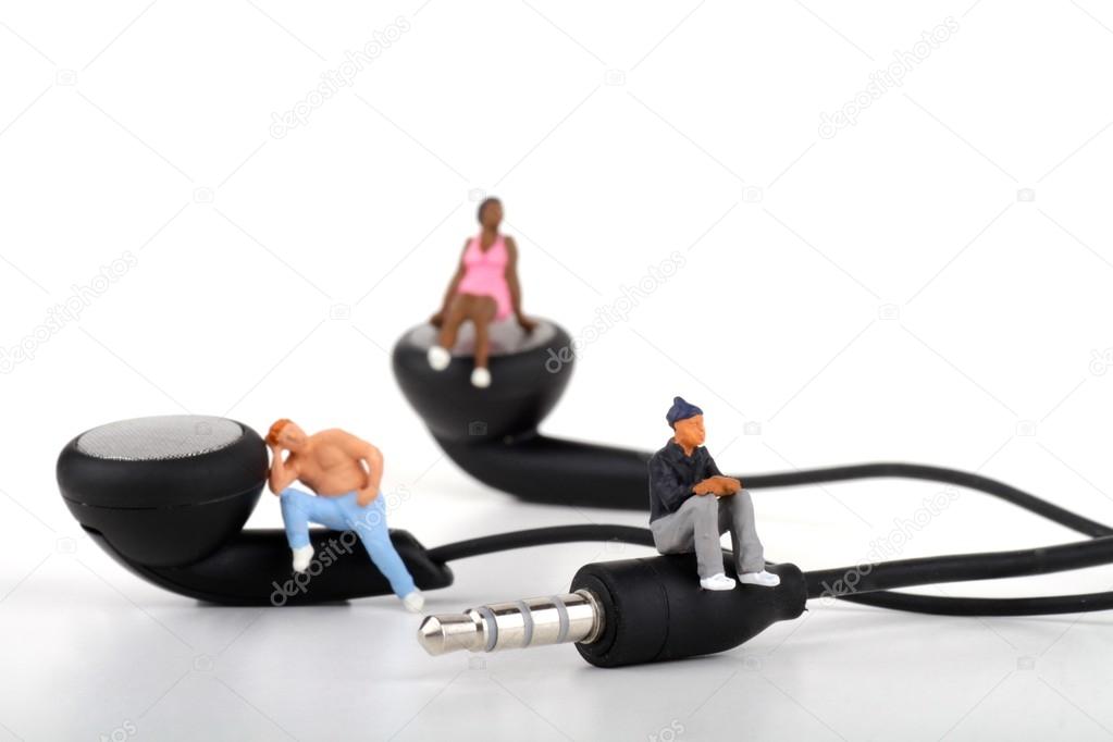 Miniatures of people standing on the earphones