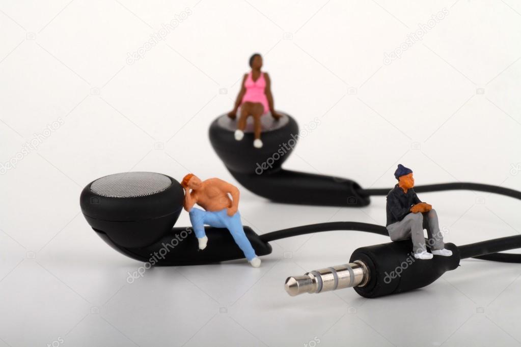 Miniatures of people standing on the earphones