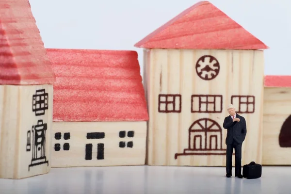 Miniatuur van een zakenman zijn horloge kijken tijdens het wachten voor iemand op een kleine stad — Stockfoto