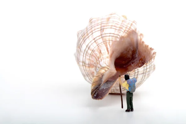 Miniature of an hiker on a big shell — Stock Photo, Image