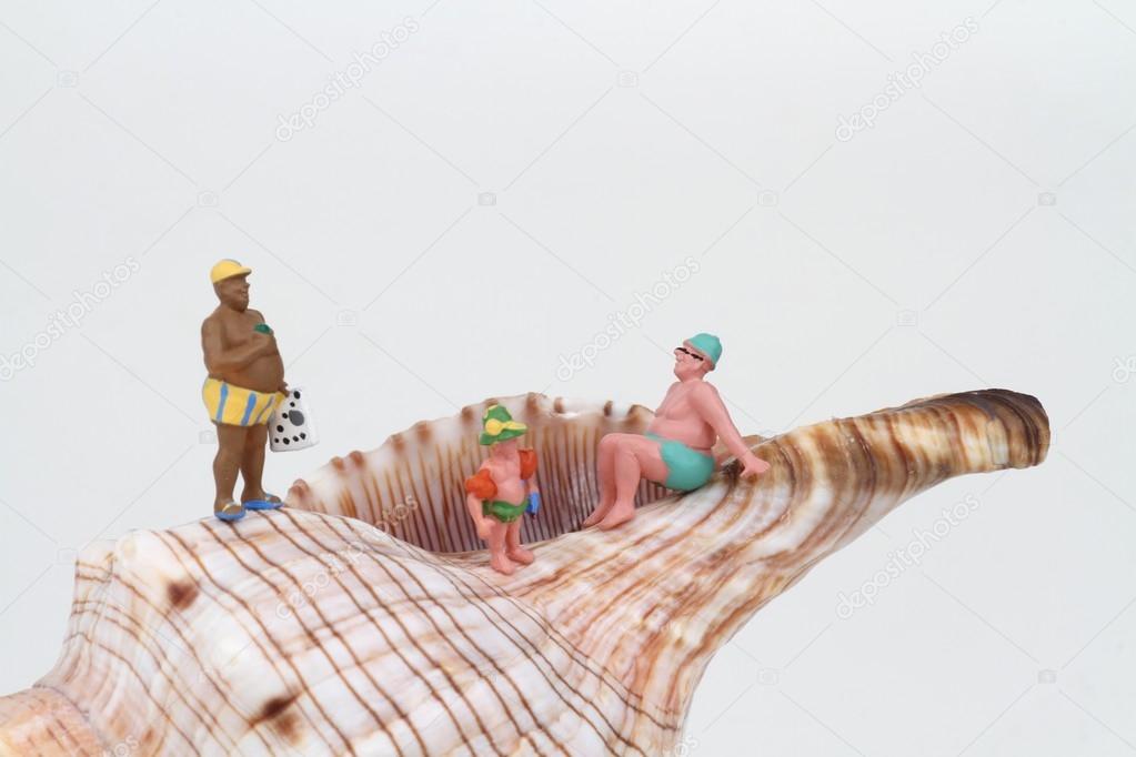 miniatures of sunbathers with a big hermit crab shell