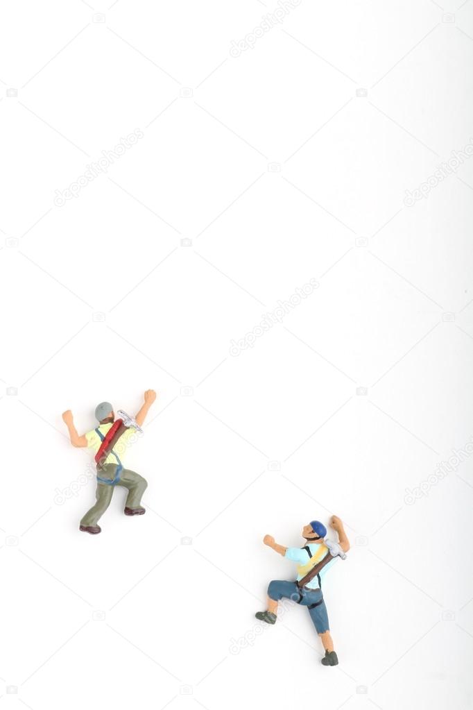 miniatures of climbers on a white background