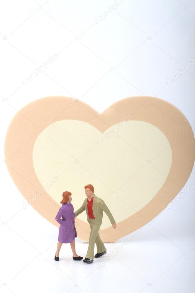 miniature of a couple with a big heart - lovers concept / Valentine' s day