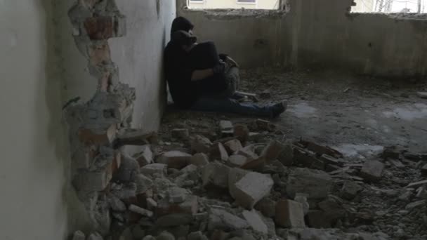 Depressed young couple sitting in an abandoned building — Stock Video