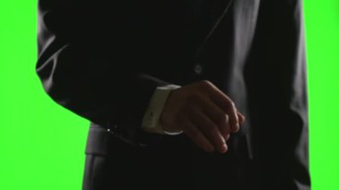 Genç işadamı yeşil ekran üzerinde bir sanal iş ortamında el hareketleri yapma