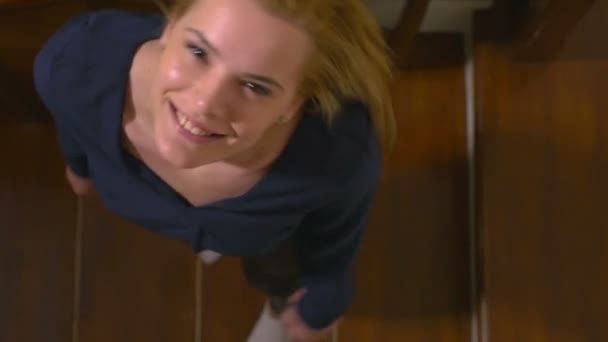 Vista de ángulo alto de una joven mujer atractiva feliz en las escaleras — Vídeos de Stock